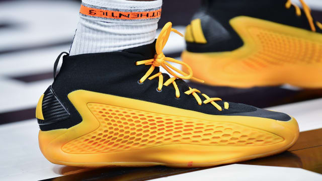 Minnesota Timberwolves guard Anthony Edwards' gold and black adidas sneakers.